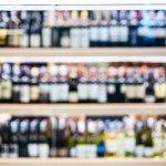 blurred-wine-liquor-bottles-on-shelf-wholesale-shop-picture-id494194002